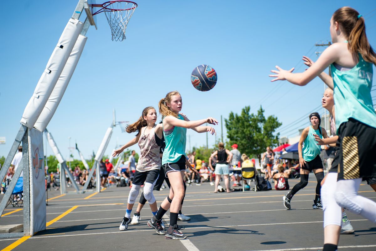 In a girls’ contest, members of Hoop I Did It Again play against Snap Crackle Pop during Hoopfest in June 2019 in downtown Spokane.  (Libby Kamrowski/Spokesman-Review)