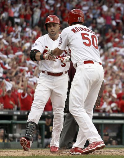 St. Louis Cardinals' Carlos Beltran (3) is congratulated by Adam Wainwright (50) as he crosses home plate after hitting a three-run home run in Game 1 of baseball's National League division series. (AP)