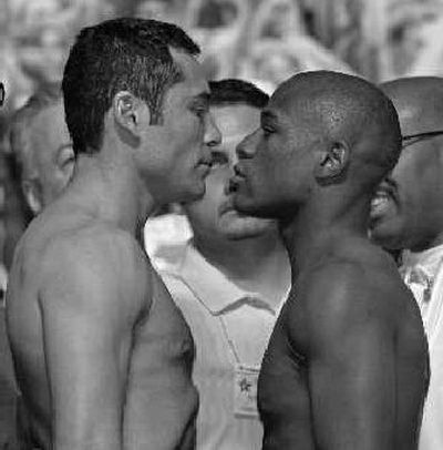 
Oscar De La Hoya, left, and Floyd Mayweather Jr. posture at weigh-in. 
 (Associated Press / The Spokesman-Review)