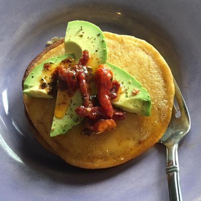 These creamy and savory tamale pancakes – topped with sundried tomatoes and avocado – offer south-of-the-border flavor for breakfast. (Adriana Janovich)