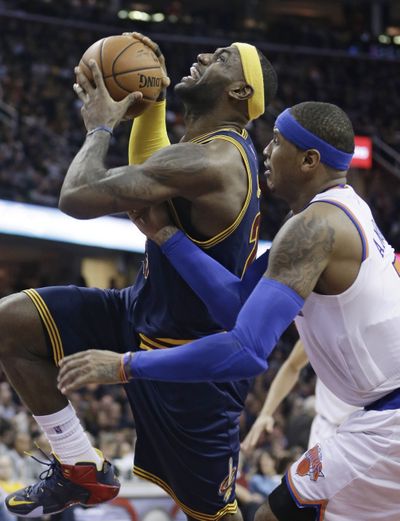 New York's Carmelo Anthony, right, fouls Cleveland's LeBron James during the fourth quarter on Thursday. (Associated Press)