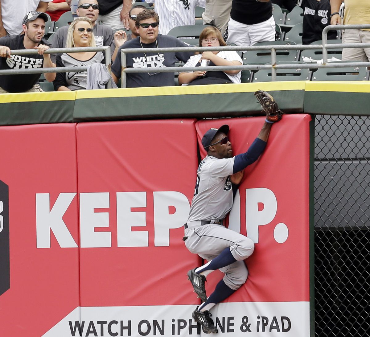 M’s center fielder James Jones crashes into wall after making running catch of ball hit by Jose Abreu in fourth. (Associated Press)