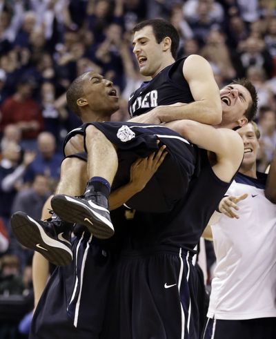 Butler guard Alex Barlow, center, is lifted up by his teammates after Barlow hit the game-winning jumper with 2.4 seconds left. (Associated Press)