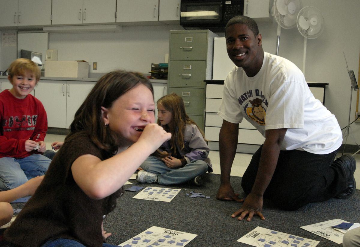 Progress second-grader Pat’yn Williamson laughs with volunteer Claudell Whitman during an instrument bingo game in music teacher Gwen Cadeallader’s class on Wednesday. (J. Rayniak / The Spokesman-Review)