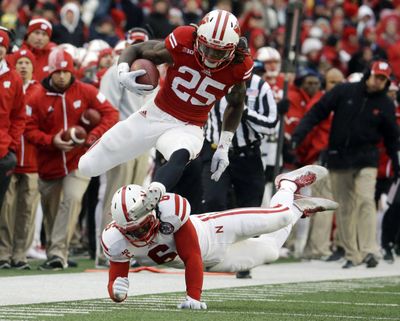 Wisconsin's Melvin Gordon breaks away from Nebraska's Corey Cooper for a 62-yard touchdown run during his record-setting game. (Associated Press)