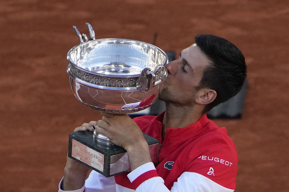 Serbia’s Novak Djokovic kisses the cup after defeating Stefanos Tsitsipas of Greece during their final match of the French Open on Sunday in Paris.  (Christophe Ena)