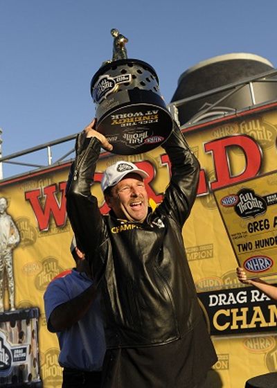 Greg Anderson raises the 2010 NHRA Full Throttle Drag Racing Series Pro Stock championship. (Photo courtesy of NHRA)