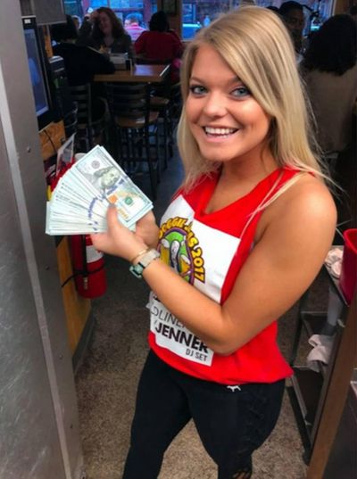 Sup Dogs server and ECU student Alaina poses with the $10,000 cash tip YouTuber Mr. Beast left her on Saturday, Oct. 20, 2018. (Sup Dogs)