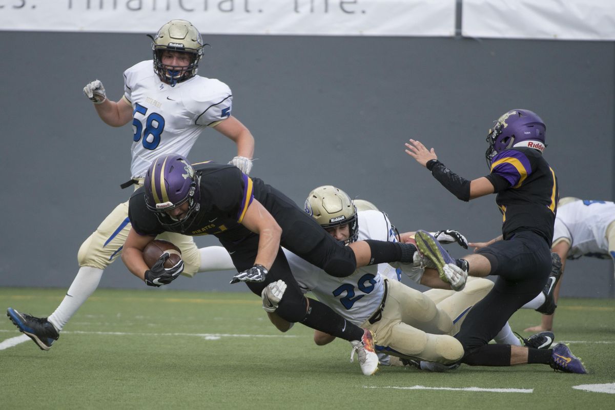 Rogers running back Eric McKay is tackled by Deer Parks Ethan Newman during the first half of a GSL high school football game, Friday, Sept. 2, 2016, at Joe Albi Stadium. (Colin Mulvany / The Spokesman-Review)