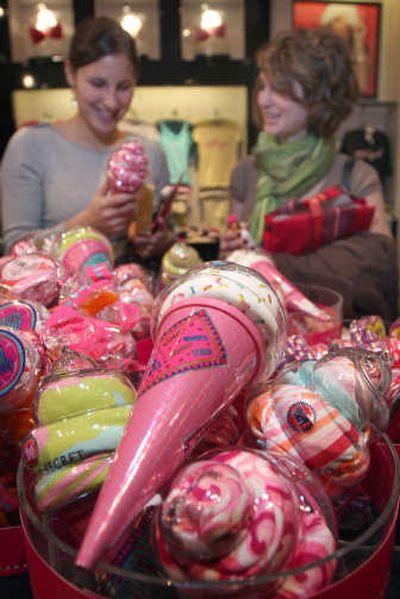 
Customers Halle Runion, left, and Samantha Anthony look at underwear packaged to look like an ice cream cone at a Victoria's Secret store in the Kenwood Towne Centre in Cincinnati on Dec. 5. Victoria's Secret is using special promotions to heat up what's been slow mall traffic. Associated Press
 (Associated Press / The Spokesman-Review)