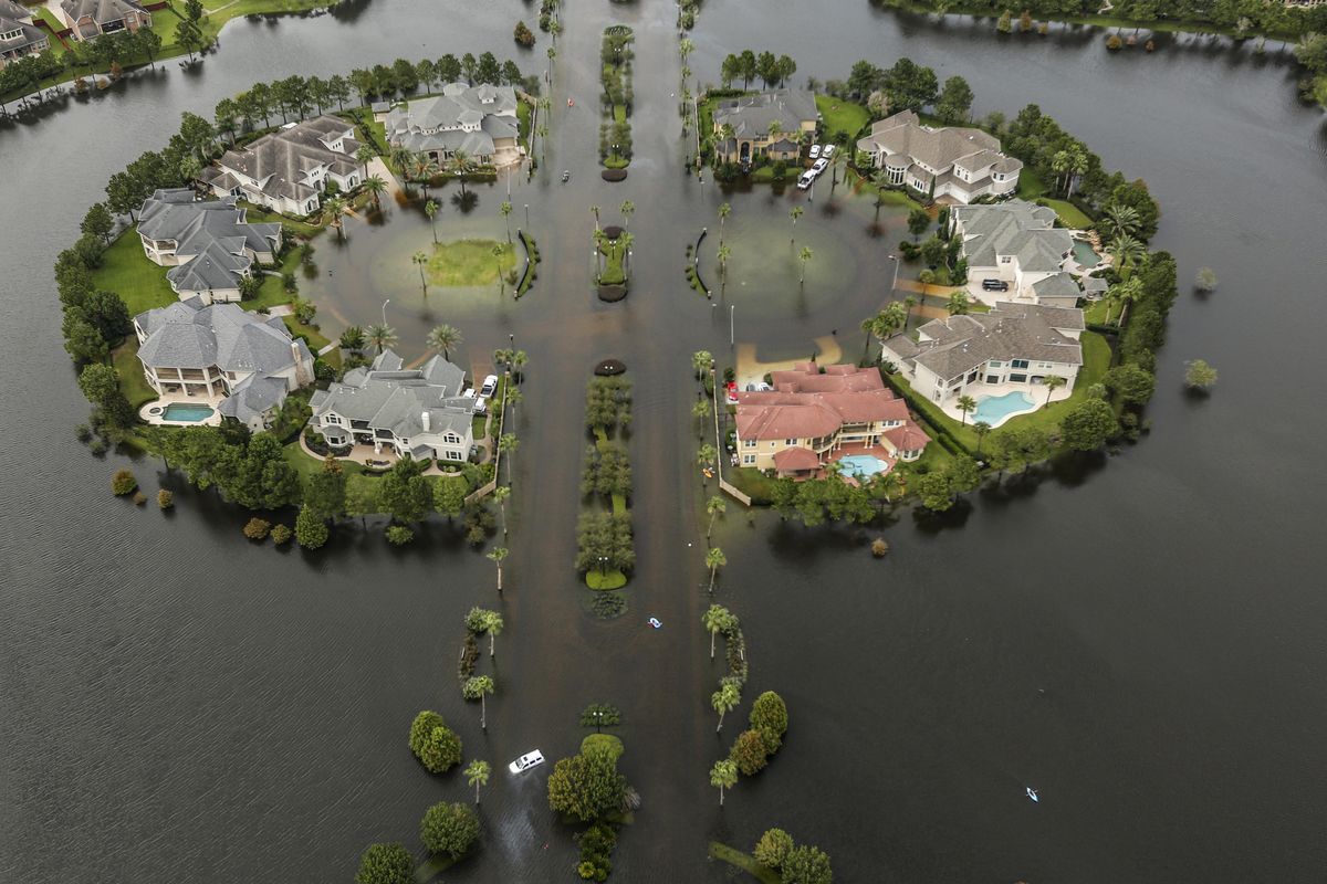 Floodwaters fill the road running through the Lakes On Eldridge North subdivision in the aftermath of Tropical Storm Harvey on Wednesday, Aug. 30, 2017, in Houston. (Brett Coomer / Houston Chronicle via AP)