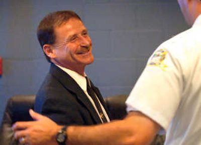 
Incoming Coeur d'Alene Police Chief Wayne Longo greets Fire Chief Kenny Gabriel at Coeur d'Alene City Hall on Wednesday.
 (Jesse Tinsley / The Spokesman-Review)