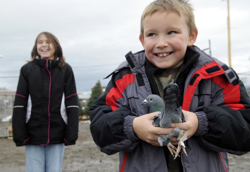 Six-year old Shain  Cothren of Suncrest holds a homing pigeon, Sunday, that will fly to the North Pole to deliver his Christmas wish list (attached to the right leg) to Santa Claus. He asked for a monster house and a Transformer.  (PHOTOS BY J. BART RAYNIAK)