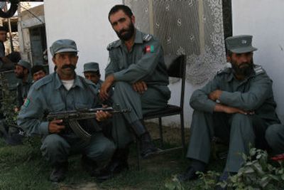
Afghan police officers pose at a checkpoint in Kabul on Monday. 
 (Associated Press / The Spokesman-Review)