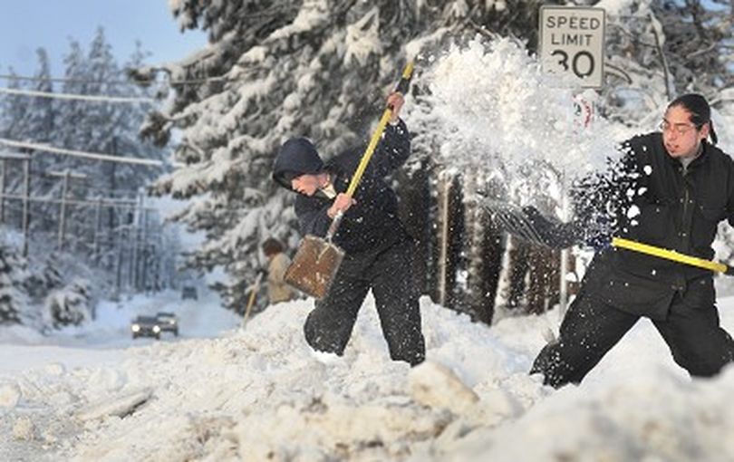 Berm busters Derek Zimmerman ( left ) and Ramon Molina clear a Spokane Washington driveway on east 37th Monday January 28, 2007. With a record snowfall the street plowing piled huge berms at driveways and crosswalks.  CHRISTOPHER ANDERSON The Spokesman-Review (Christopher Anderson / The Spokesman-Review)