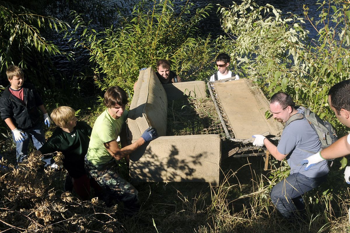 Bubba Ferguson, Tyler Zandhuisen, Chris Lewis, Kaleb Allen, Aaron Danneker and Loren Vanden Berg muscle up a hide-a-bed couch from the banks of the Spokane River near  South Riverton and Desmet during the Seventh Annual Spokane River Clean-Up.  (Dan Pelle / The Spokesman-Review)