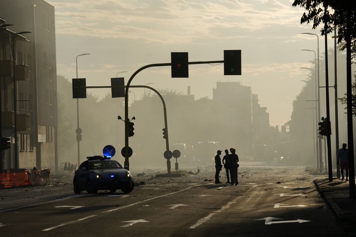 Police patrol the area where a building went on fire in Milan, Italy, Sunday, Aug. 29, 2021.  (Luca Bruno)