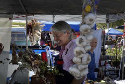 
Shoppers  tour the Bonners Ferry Farmers Market Garlic Festival on Saturday.  The festival featured live music, a cook-off and dozens of booths selling goods. 
 (Photos by JED CONKLIN / The Spokesman-Review)