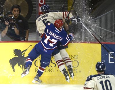 The Spokane Chiefs’ Kailer Yamamoto throws all he’s got into a check on the Tri-City Americans’ Juuso Valimaki, earning a penalty for checking in the back Saturday, Sept. 26, 2015 at the Spokane Arena, the Chiefs’ season opener. (Jesse Tinsley / The Spokesman-Review)