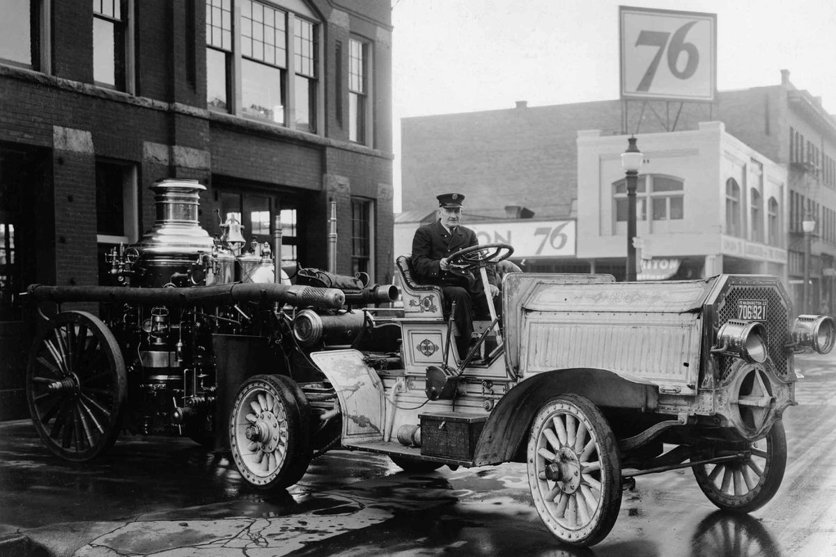 1935: Engineer O.J. McDonald drives out one of the original motor units built in the teens to pull the former horse-drawn pumper units. These were built by members of the fire department in a machine shop that sat behind Station No. 3 at Sharp Avenue and Monroe Street.