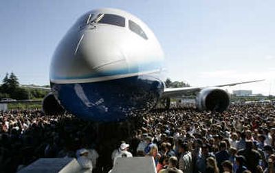 
Visitors crowd around the first production model of the new Boeing 787 Dreamliner airplane during a July ceremony at Boeing's assembly plant in Everett. 
 (File Associated Press / The Spokesman-Review)