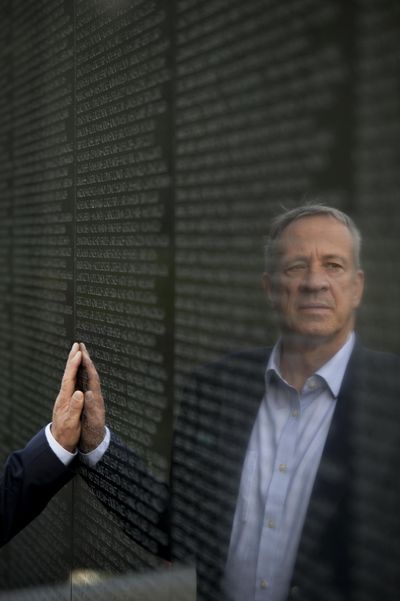 Jan Scruggs touches the Vietnam Veterans Memorial in 2012. (Matt McClain / Washington Post)