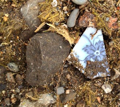 A broken piece of pottery on the ground beneath near the Monroe Street Bridge hint's at Spokane's past (Cheryl-Anne Millsap / photo by Cheryl-Anne Millsap)