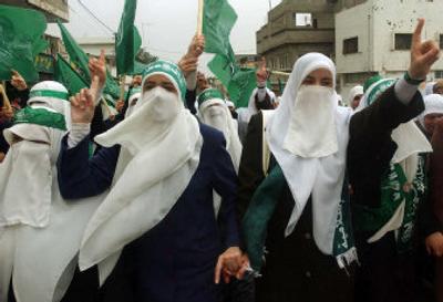 
Palestinian supporters of the Islamic group Hamas chant slogans during a rally celebrating Hamas' victory in Palestinian local elections in the West Bank city of Tulkarem Friday. 
 (Associated Press / The Spokesman-Review)