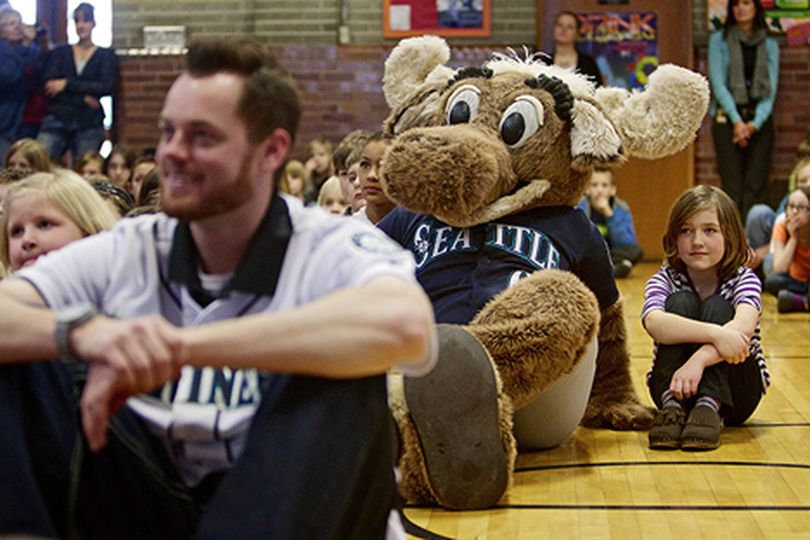 Macaylee Godin watches a highlight video with the Seattle Mariner's mascot during an assembly Thursday at Borah Elementary in Coeur d'Alene. (Jerome Pollos/press)