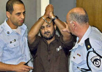 
Palestinian leader Marwan Barghouti lifts his hands as he is escorted by Israeli police into court room Thursday for the last session of his trial in Tel Aviv .Palestinian leader Marwan Barghouti lifts his hands as he is escorted by Israeli police into court room Thursday for the last session of his trial in Tel Aviv .
 (Associated PressAssociated Press / The Spokesman-Review)