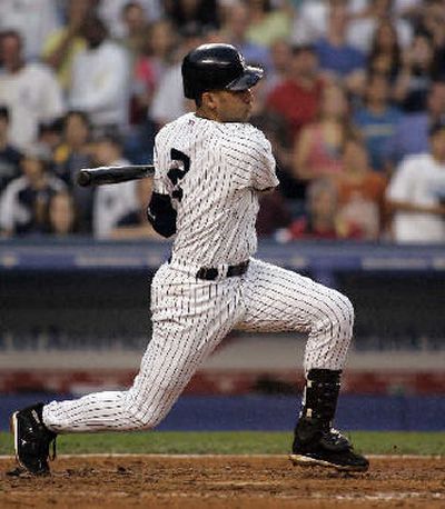 
Yankees shortstop Derek Jeter smacks his 2,000th career hit Friday in New York.
 (Associated Press / The Spokesman-Review)
