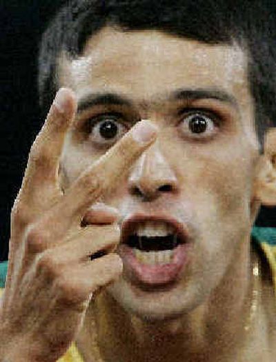 
Hicham El Guerrouj of Morocco shows how many golds he won in Athens.
 (Associated Press / The Spokesman-Review)