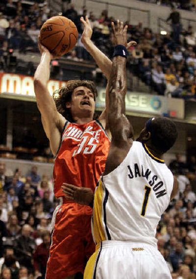 Charlotte's Adam Morrison shoots over Indiana's Stephen Jackson on his way to a career-high 30 points Saturday.
 (Associated Press / The Spokesman-Review)