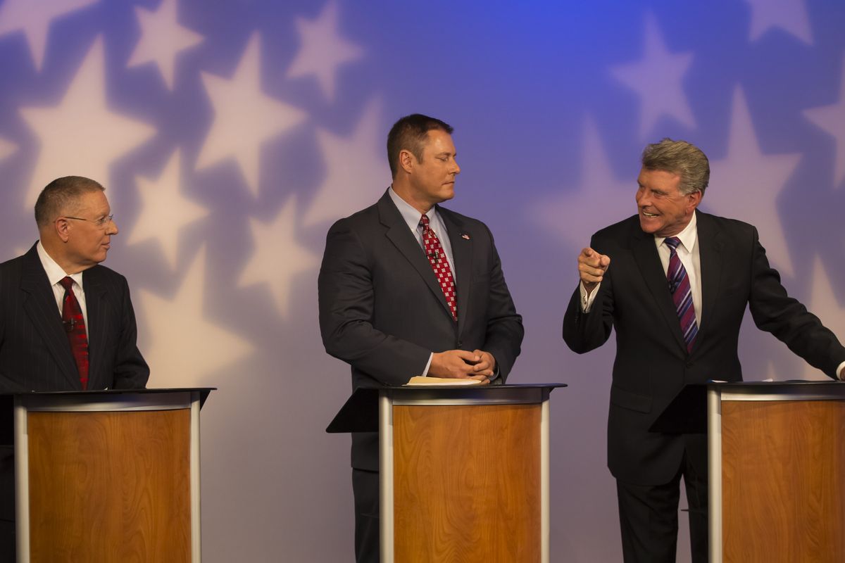 Idaho Gov. Butch Otter, right, responds past Libertarian candidate John Bujak, center, to a comment by Democratic candidate A.J. Balukoff during a debate in Boise on Thursday. (Associated Press)