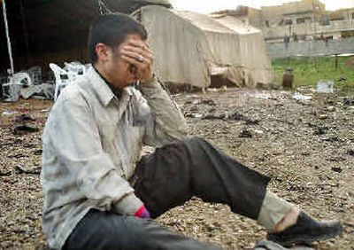 
An unidentified man grieves at the blast site after a suicide bomber blew himself up during a funeral in Mosul on Thursday. 
 (Associated Press / The Spokesman-Review)