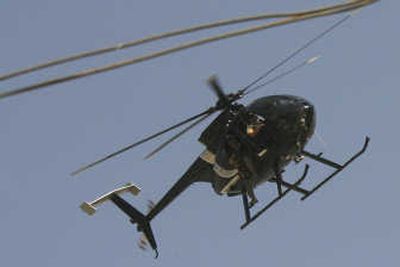 
A Little Bird helicopter, the type used by Blackwater USA,  is seen flying over central Baghdad on Wednesday after a car bomb exploded. Associated Press
 (Associated Press / The Spokesman-Review)