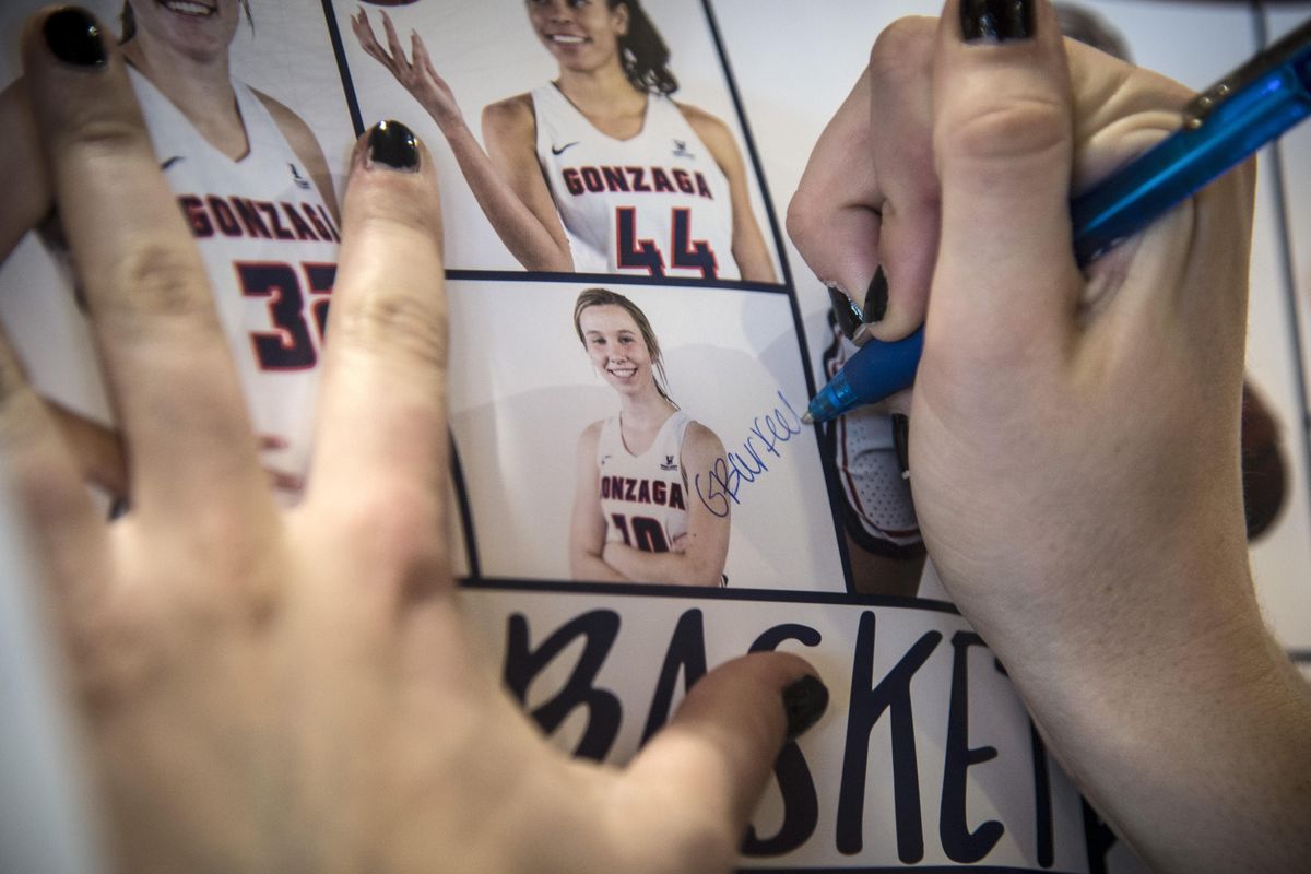 Gonzaga University forward Gillian Barfield signs her autograph to a Zag poster during FanFest, Saturday, Oct. 13, 2018. (Dan Pelle / The Spokesman-Review)