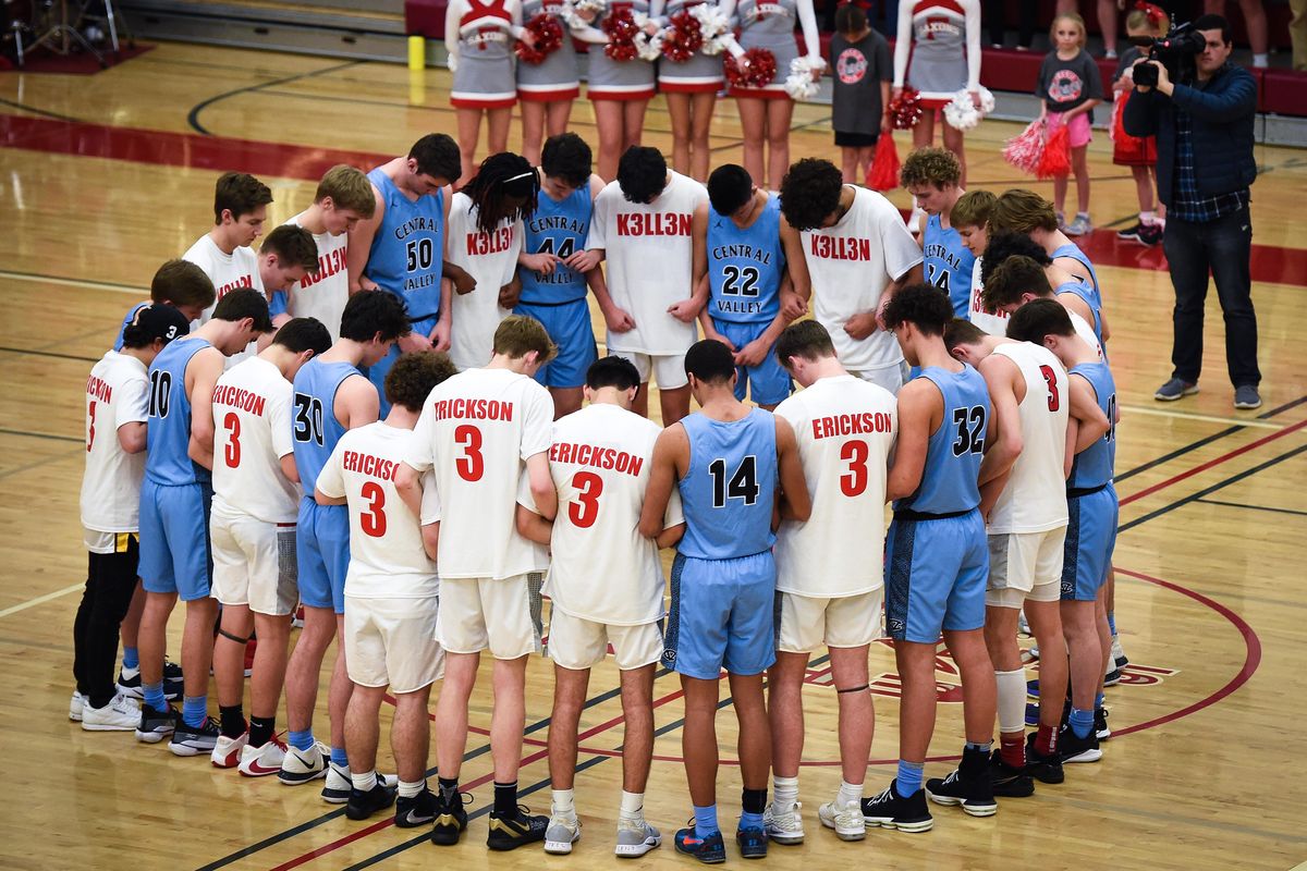 Before their GSL high school basketball game, members of the Ferris and Central Valley varsity teams gather at center court for a moment of silence in memory of Ferris High School graduate Kellen Erickson who died last week in a motor vehicle accident. (Colin Mulvany / The Spokesman-Review)
