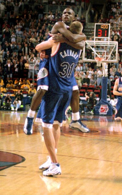 After Casey Calvary slam-dunked the ball with a minute left against Minnesota, Quentin Hall leapt to give him a celebration hug.  (Spokesman-Review Photo Archives)