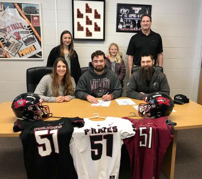 Justin Gies, center, signs his national letter of intent to play football at Whitworth University. Pictured seating left to right: Jennifer Gies, Justin Gies, Bill Gies. Standing left to right: McKenzie Gies, Rebecca Gies, Craig Christensen PFHS Activities Director. (Craig Christiansen / Courtesy)