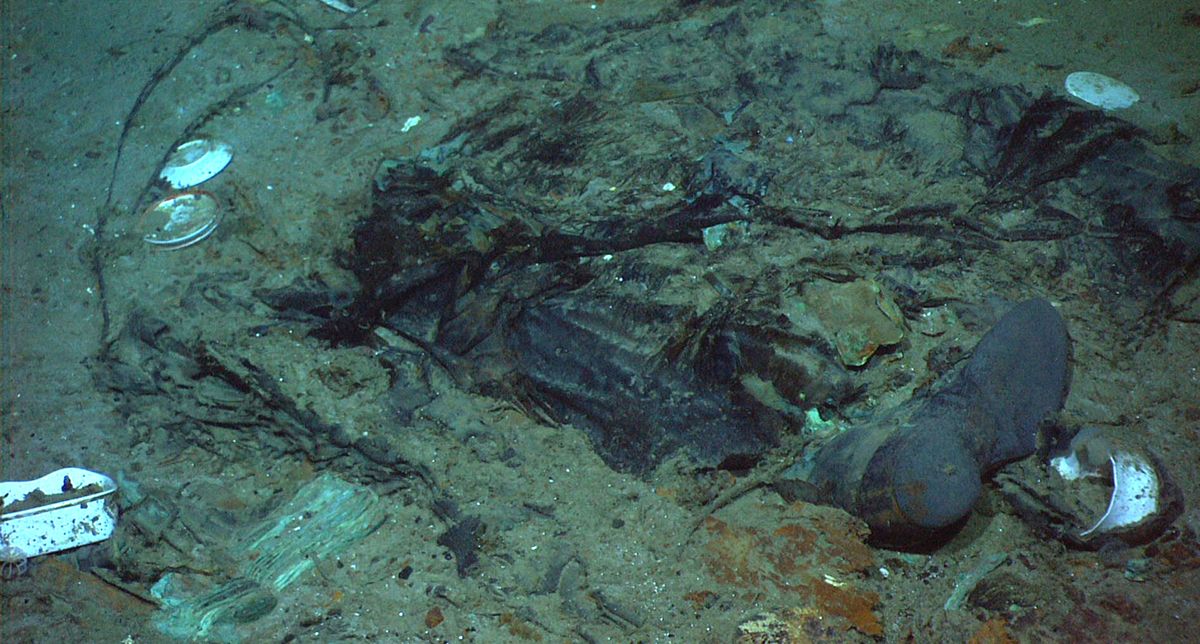 FILE - This 2004 photo provided by the Institute for Exploration, Center for Archaeological Oceanography/University of Rhode Island/NOAA Office of Ocean Exploration, shows the remains of a coat and boots in the mud on the sea bed near the Titanic