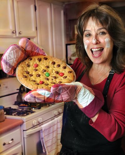 Karen Amarotico of Ashland, Ore., holds a ready-to-deliver chocolate chip pie recently. (Associated Press)