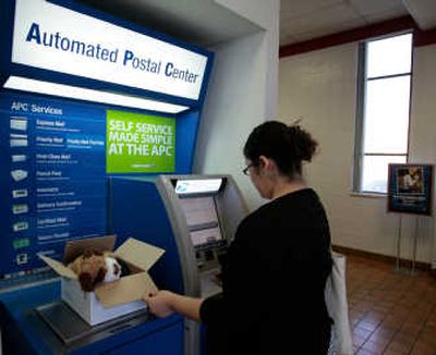 
Customer Maria Gonzalez checks the weight of her parcel at an Automated Postal Center inside a post office in Los Angeles. Postal agencies are cutting costs through automation and measures like installing kiosks to reduce labor-intensive window transactions. Associated Press
 (Associated Press / The Spokesman-Review)