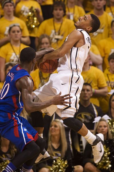 Kansas’ Tyshawn Taylor thwarts shot by Missouri’s Phil Pressey. (Associated Press)