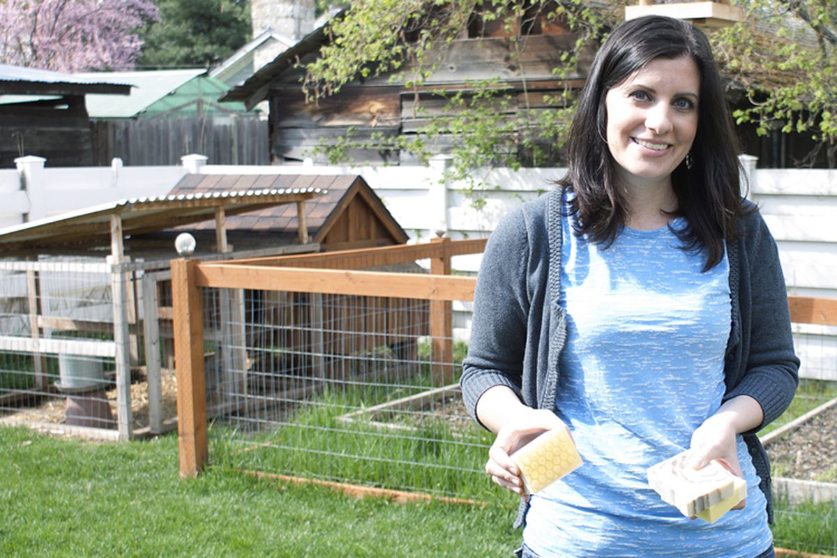 Jennifer Morsell, owner of Mountain Madness Soap, shows off three varieties of the naturally-made product in the backyard of her Coeur d