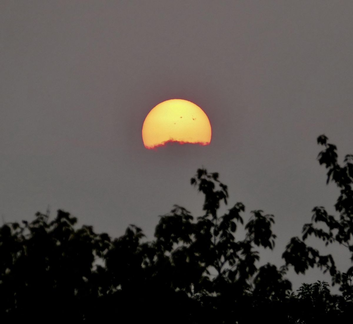 A red sun rises over distant clouds, Wednesday, Sept. 6, 2017 as seen from Spokane, Wash. (Jesse Tinsley / The Spokesman-Review)