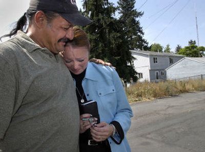 
An emotional Lisa Jones is comforted by Ralph Sandaine as he recounts finding her wallet in a parking lot. 
 (Photos by Dan Pelle / The Spokesman-Review)