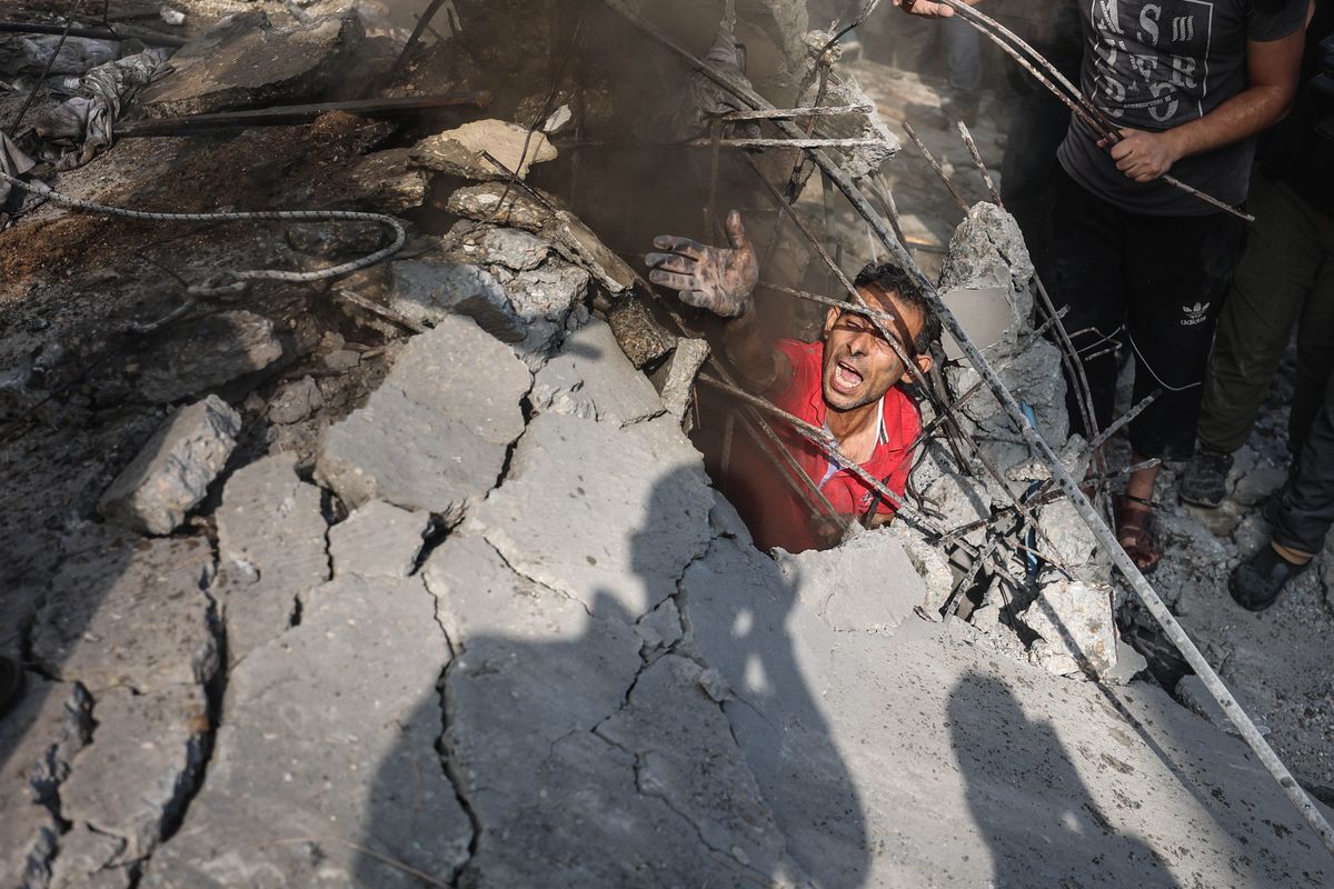Search efforts underway at a house damaged in an Israeli airstrike in Khan Younis in the southern Gaza Strip on Monday.  (Loay Ayyoub/For The Washington Post)