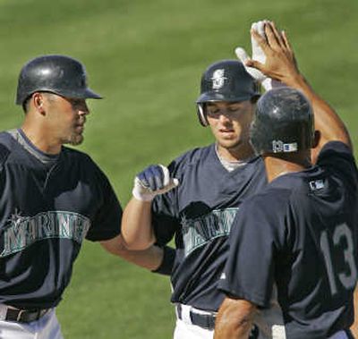 
Associated Press Matt Tuiasosopo, center, hit a three-run homer earlier this spring.
 (Associated Press / The Spokesman-Review)