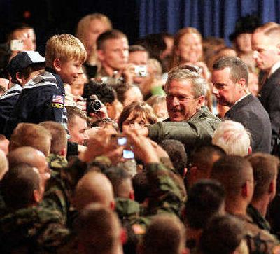 
President George W. Bush shakes hands with the crowd as he leaves after speaking to military personal and their families at Elmendorf Air Force in Anchorage, Alaska, on Monday. 
 (Associated Press / The Spokesman-Review)